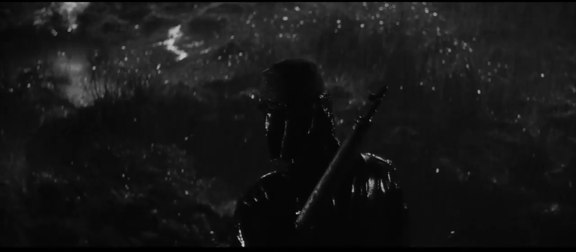 Kaji trudging through the rain in the third part of the trilogy